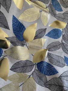 Toile de Coton Feuilles métallisés dorées et bleu sur fond Ecru